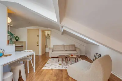 a living room with a couch and a table at ATTIC URBAN AP4485 by Riviera Holiday Homes in Nice