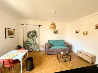 a living room with a couch and a table at Charmant studio près de la plage et la Promenade des Anglais in Nice