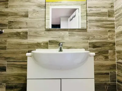 a bathroom with a white sink and a mirror at Cosy studio au Coeur du Centre Ville in Nice