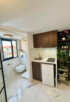 a small kitchen with a sink and a toilet at Place Massena - Small Peaceful Haven in Nice