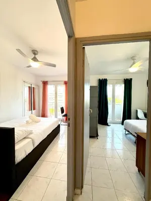 a bedroom with two beds and a room with a mirror at Charmant appartement 3 pièces au cœur de Nice in Nice