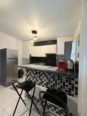 a kitchen with black and white tile on the counter at Charmant appartement 3 pièces au cœur de Nice in Nice