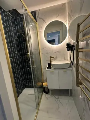 a bathroom with a sink and a shower with a mirror at MOON 41 - Appartement Nice 4P in Nice