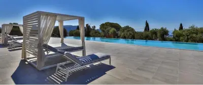 a pair of lounge chairs sitting next to a swimming pool at Le 120 m2 - luxe, piscine, terrasse et garage in Nice