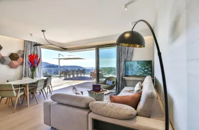 a living room with a couch and a table at Le 120 m2 - luxe, piscine, terrasse et garage in Nice