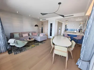 a living room with a couch and a table at Le 120 m2 - luxe, piscine, terrasse et garage in Nice