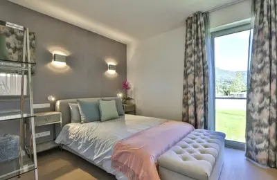 a bedroom with a large bed and a window at Le 120 m2 - luxe, piscine, terrasse et garage in Nice