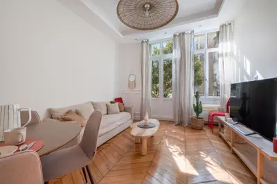 a living room with a couch and a tv at Soleil Niçois Terracotta in Nice