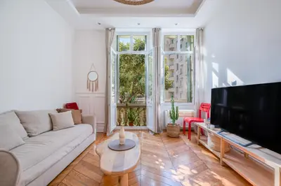 a living room with a couch and a flat screen tv at Soleil Niçois Terracotta in Nice