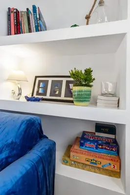 a shelf with books and a potted plant on it at Le Garibaldi - City centre - Bright - AC in Nice
