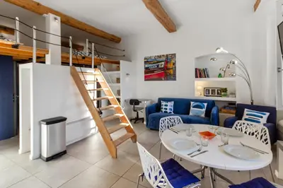 a living room with a table and a loft bed at Le Garibaldi - City centre - Bright - AC in Nice