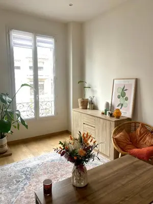 a living room with a table and a window at 2 pièces avec balcon au port de Nice in Nice