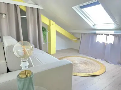 a living room with a white couch and a window at Cosy sous les toits - Nice Gare - 2 pers in Nice