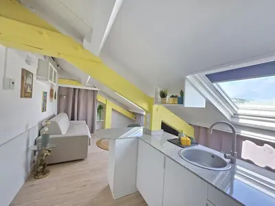an attic kitchen with a sink and a window at Cosy sous les toits - Nice Gare - 2 pers in Nice