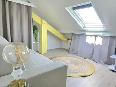 a living room with a couch and a window at Cosy sous les toits - Nice Gare - 2 pers in Nice
