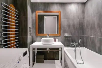 a bathroom with a sink and a tub and a mirror at Havre de Paix Mont Boron Proche du Port in Nice