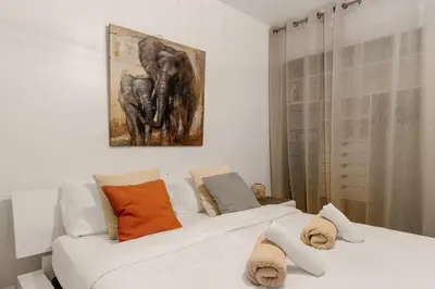 a bedroom with two beds and a painting on the wall at Havre de Paix Mont Boron Proche du Port in Nice