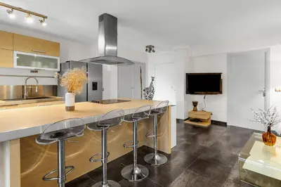 a kitchen with a counter and bar stools at Havre de Paix Mont Boron Proche du Port in Nice