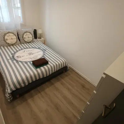 a bedroom with a bed with two faces on it at Beau T3 tout équipé avec grand écran et Wi-Fi performant in Nice