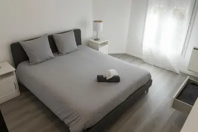 a bedroom with a large bed with a hat on it at Beau T3 tout équipé avec grand écran et Wi-Fi performant in Nice