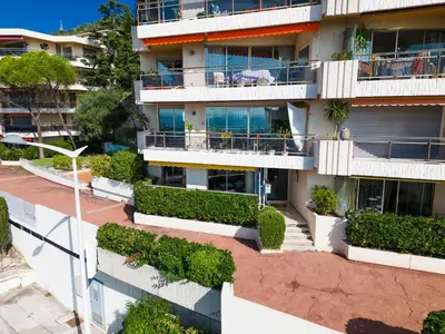 an apartment building with plants on the balconies at Nice Renting - CARNOT - Escape to French Riviera Terrace with Sea View in Nice