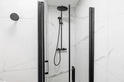 a shower with a shower head in a bathroom at Nice Renting - CARNOT - Escape to French Riviera Terrace with Sea View in Nice