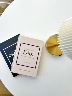 a plate with a book and a mirror and a comb at Studio sur la promenade des anglais in Nice