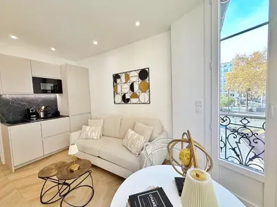 a living room with a couch and a table at Studio sur la promenade des anglais in Nice
