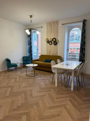 a living room with a couch and a table at MOON 24 - Appartement Nice 6P in Nice