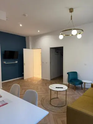 a living room with a couch and a table and chairs at MOON 24 - Appartement Nice 6P in Nice