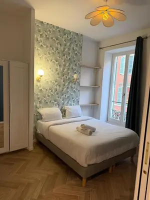 a bedroom with a large bed with a large window at MOON 24 - Appartement Nice 6P in Nice