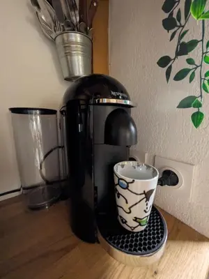a coffee maker and a cup on a counter at Palais des arts in Nice