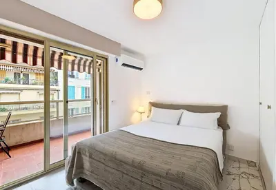 a bedroom with a bed and a large window at Nestor&Jeeves - LE SAGITTAIRE - Terrasse, proche mer in Nice