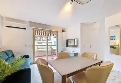 a living room with a table and a couch at Nestor&Jeeves - LE SAGITTAIRE - Terrasse, proche mer in Nice