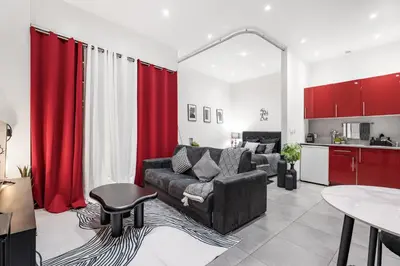 a living room with a couch and red curtains at Nice Renting - GALLO - New Modern Loft Old Town Massena in Nice