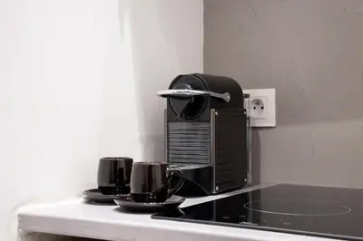 a microwave sitting on a counter with two coffee cups at Nice Renting - GALLO - New Modern Loft Old Town Massena in Nice