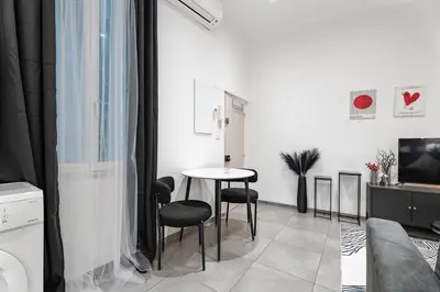 a white living room with a table and chairs at Nice Renting - GALLO - New Modern Loft Old Town Massena in Nice