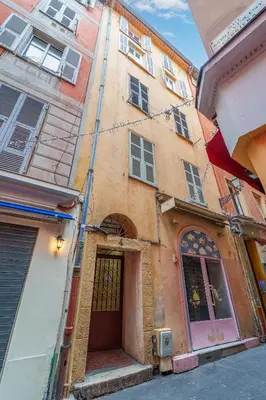 an old building with a door in a street at Nice Renting - GALLO - New Modern Loft Old Town Massena in Nice