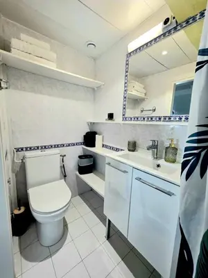 a bathroom with a toilet and a sink and a mirror at Mansarde Lumineuse - Nice Gare 2 pers in Nice