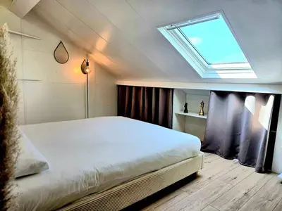 a bedroom with a large white bed with a skylight at Mansarde Lumineuse - Nice Gare 2 pers in Nice