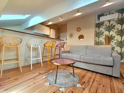a living room with a couch and a table and chairs at Design et confort - Nice Centre 4 pers in Nice