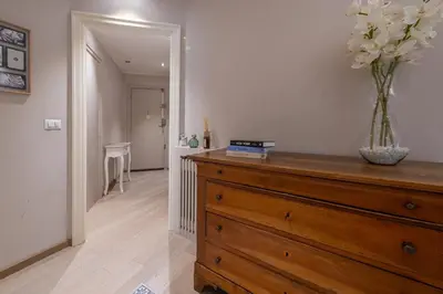 a room with a dresser with a vase of flowers on it at chloe in Beaulieu-sur-Mer