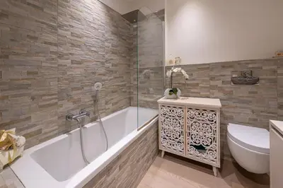 a bathroom with a tub and a toilet and a sink at chloe in Beaulieu-sur-Mer