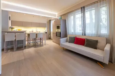 a living room with a couch and a kitchen at chloe in Beaulieu-sur-Mer