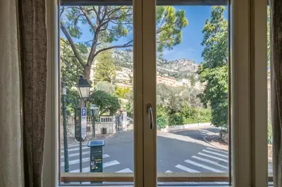 a window with a view of a street at chloe in Beaulieu-sur-Mer