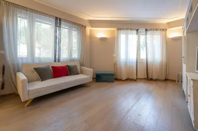 a living room with a couch and large windows at chloe in Beaulieu-sur-Mer
