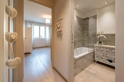 a large bathroom with a tub and a sink at chloe in Beaulieu-sur-Mer