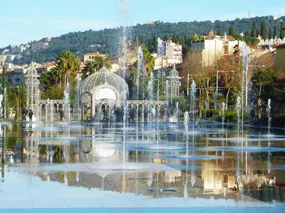 a fountain in the middle of a pond in a city at 