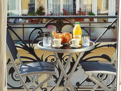 a table with drinks and food on a balcony at 