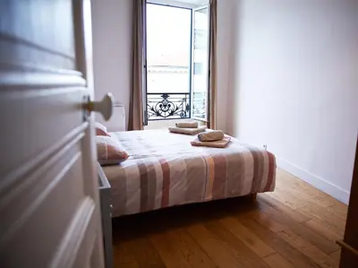 a small bedroom with a bed with a window at 
